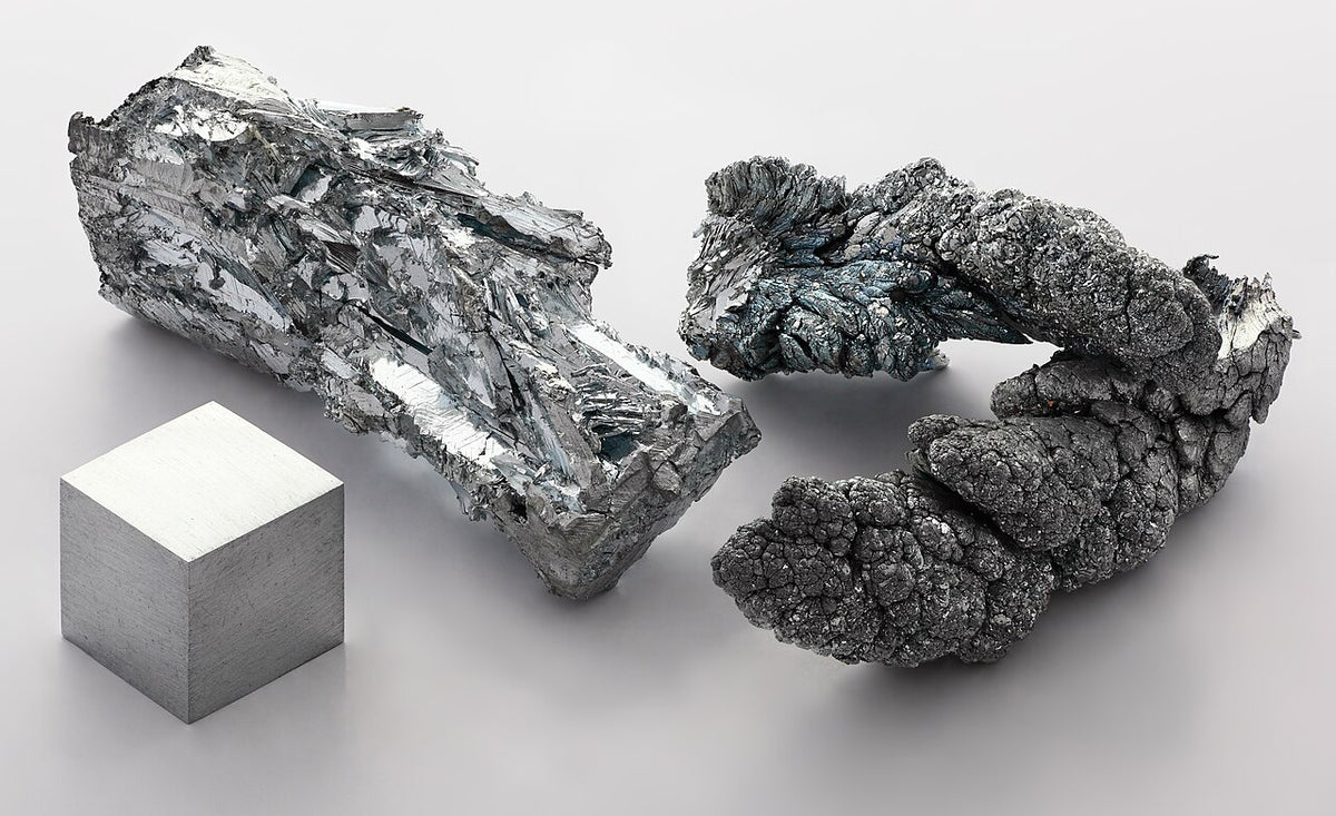 Zinc metal fragments and a 1cm zinc cube