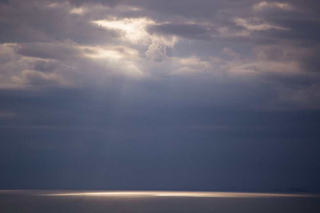 Sunlight breaking through dark clouds