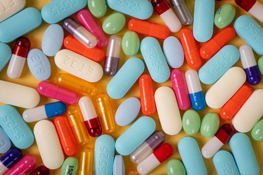 Close-up of supplement pills and capsules on a dark surface