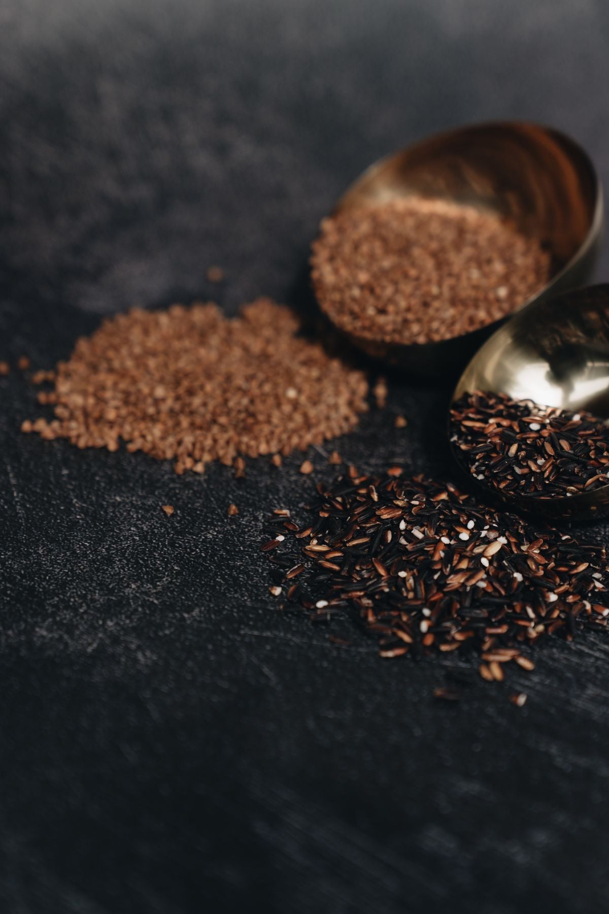 Whole grains and rice on a dark surface, a dietary source of vitamin B1 thiamine
