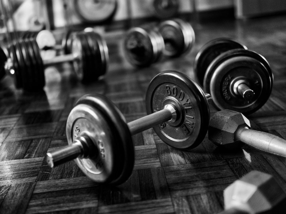 Dumbbells on a gym floor in low light
